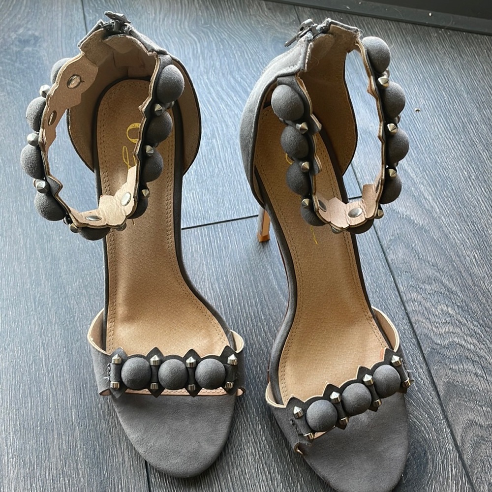 Super fashionable gray sandal with to die for embellished jewelry